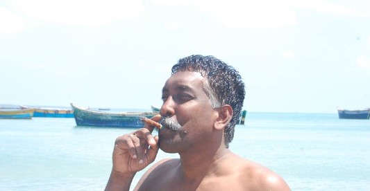 Joe D'Cruz while smoking a cigar