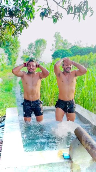 Nitesh Kumar (left) having fun on the tubewell of his village